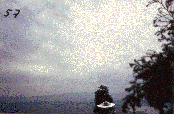 #57.[32] Semjase flying with her beamship around a wettertanne (weather pine) 14m height (the tree later eliminated by Semjase). Pfaffikersee in background. 9th July 1975.